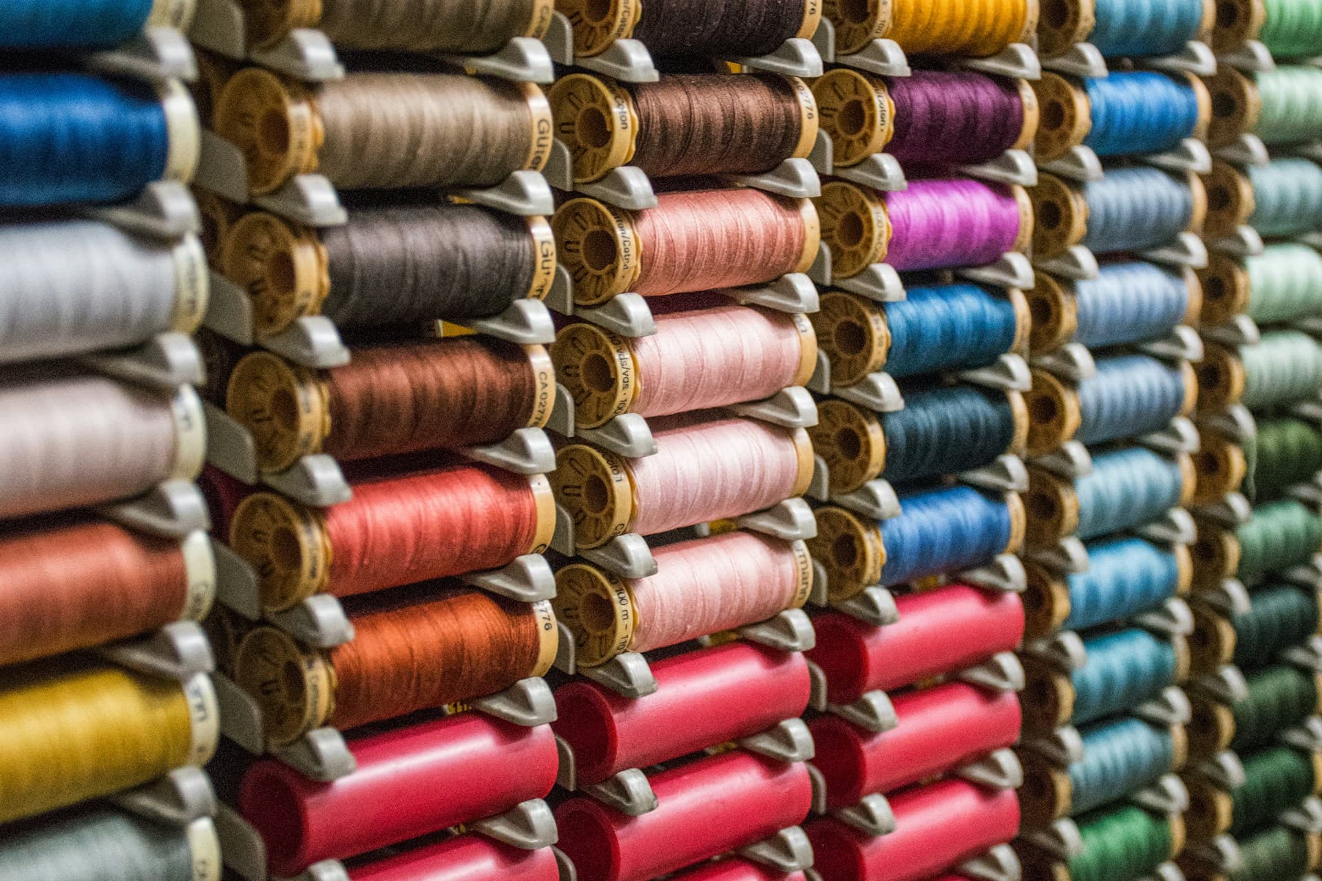 An array of colourful threads in a haberdashery display